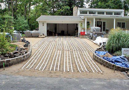 Electric heating cable being installed for a large heated driveway with pavers.