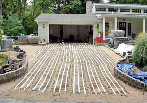 A heated driveway under pavers being installed.
